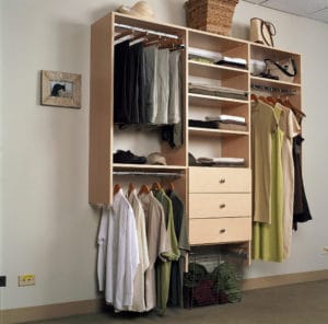 CUSTOM REACH-IN CLOSET DESIGN DIVIDES HIS AND HERS SPACES