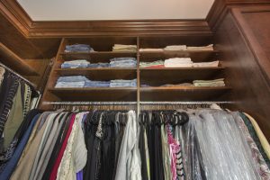 ALL WOOD STAINED CUSTOM CLOSET WITH SHELVING AND CROWN MOLDING