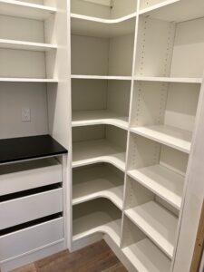 WALK-IN PANTRY WITH PULL-OUTS CORNER SHELVING AND ADJUSTABLE SHELVING by Austin-Morgan Closets